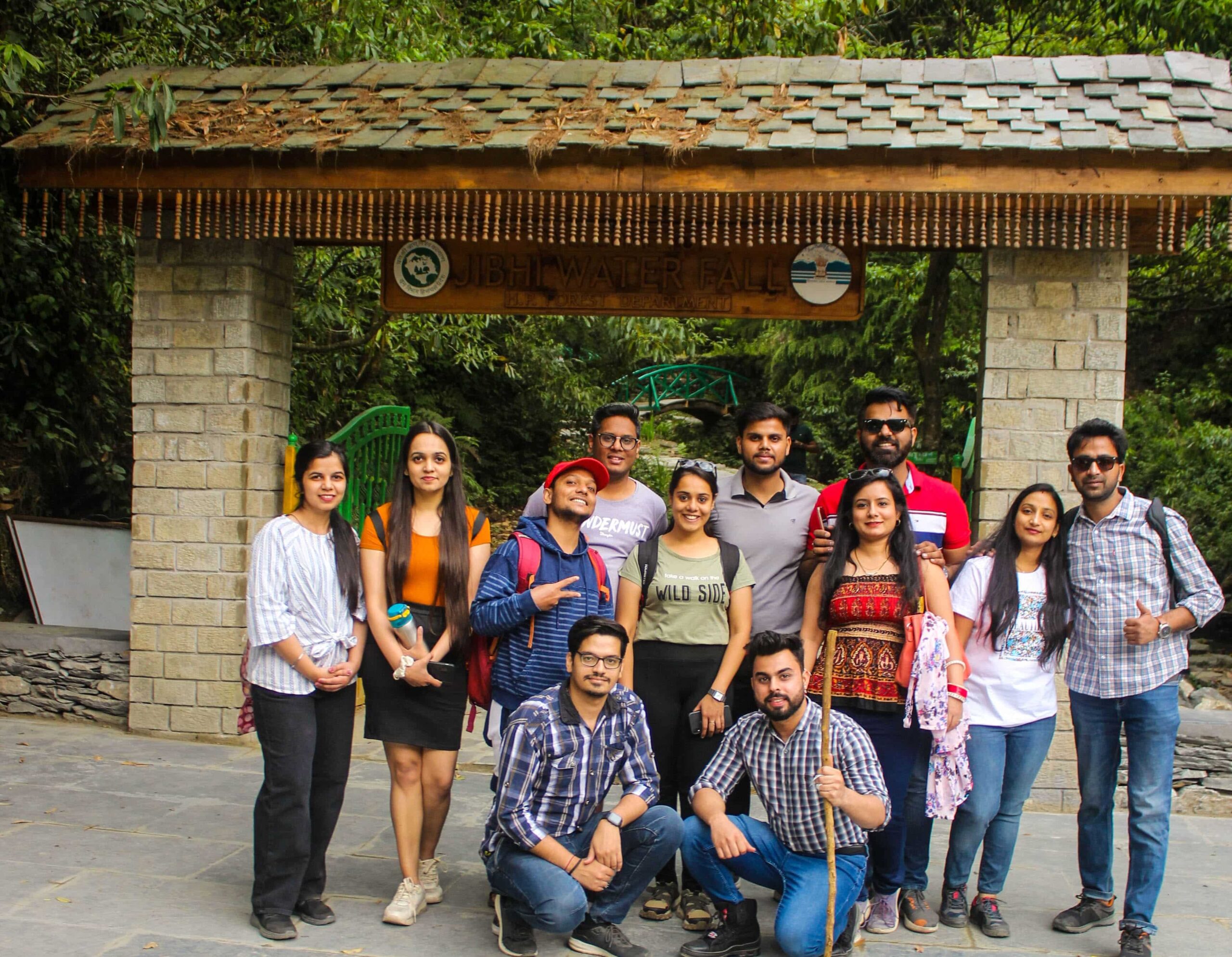 Offbeat Himachal tour scenic view of Jibhi village with riverside cottages and lush green mountains