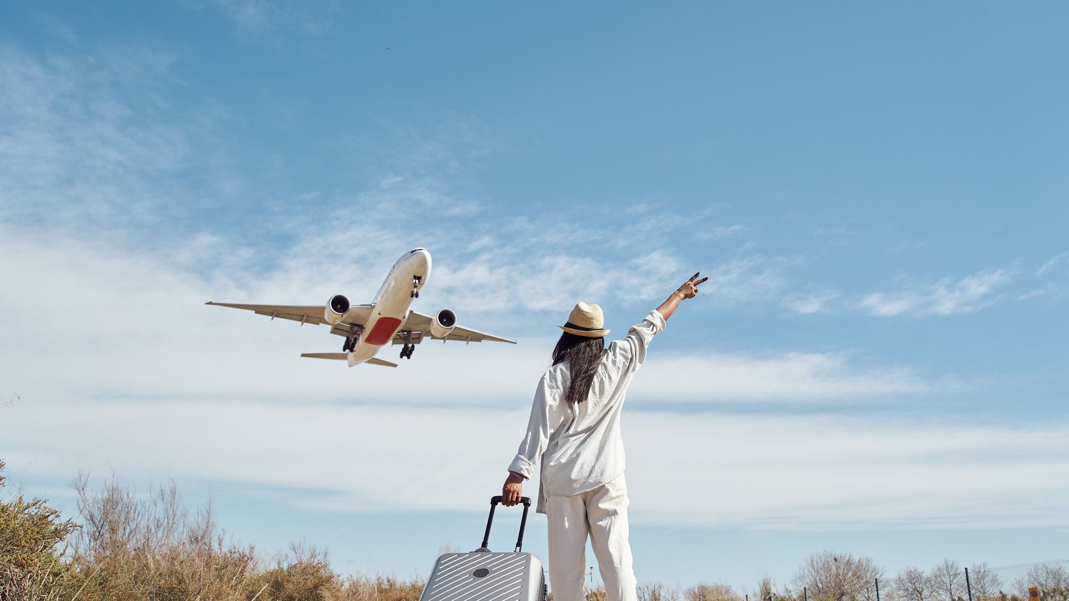 Traveler planning how to plan the best trip in international on a budget with passport, laptop, flight tickets and travel notes
