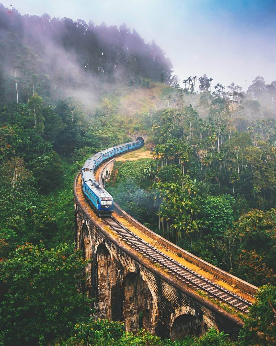A solo backpacker walking on a scenic mountain trail, illustrating how to travel on a budget.