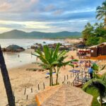 A beautiful, isolated Palolem Beach in Goa during sunrise, with soft sand and gentle waves.