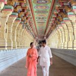 The long, highly ornate corridor of the Ramanathaswamy Temple in Rameswaram, Tamil Nadu, lined with intricately carved stone pillars.