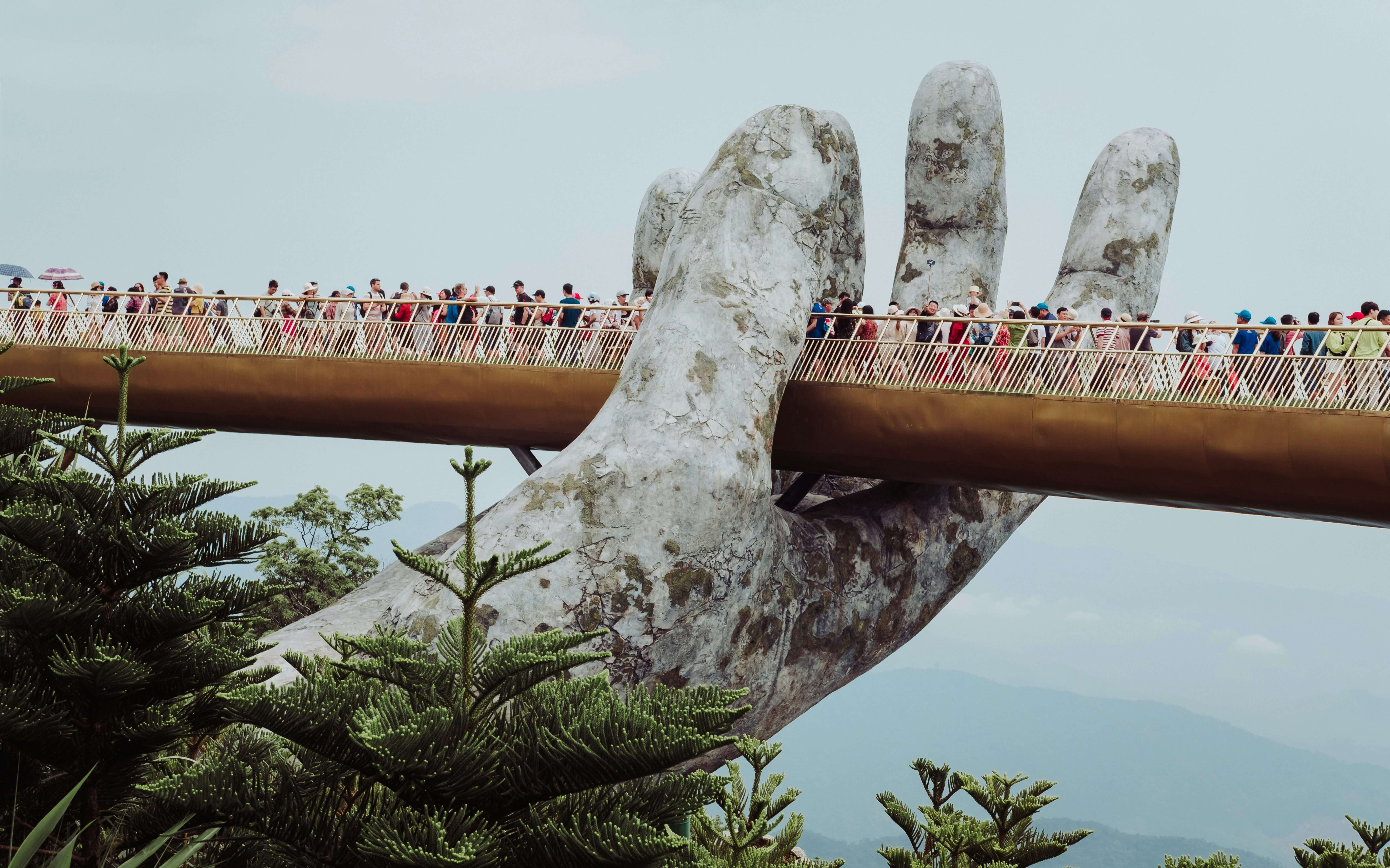 Limestone karsts and emerald waters of Halong Bay, Vietnam package, with a traditional junk boat cruising.