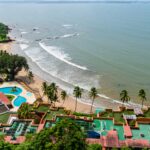 Luxury beach resort with palm trees and ocean view in Goa