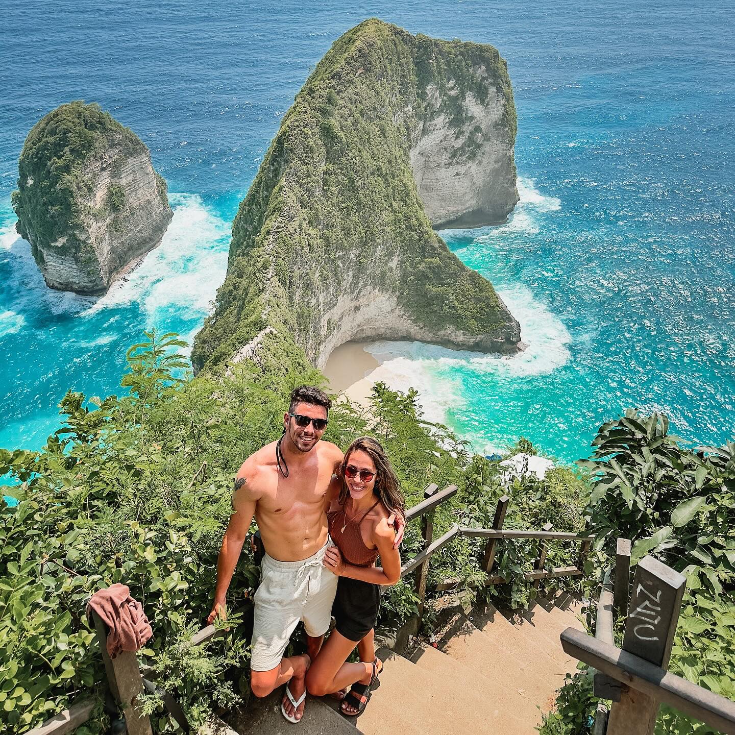 "The dramatic, rugged coastline of Nusa Penida, Bali, featuring towering limestone cliffs plunging into the turquoise Indian Ocean, with a pristine, secluded beach at their base."