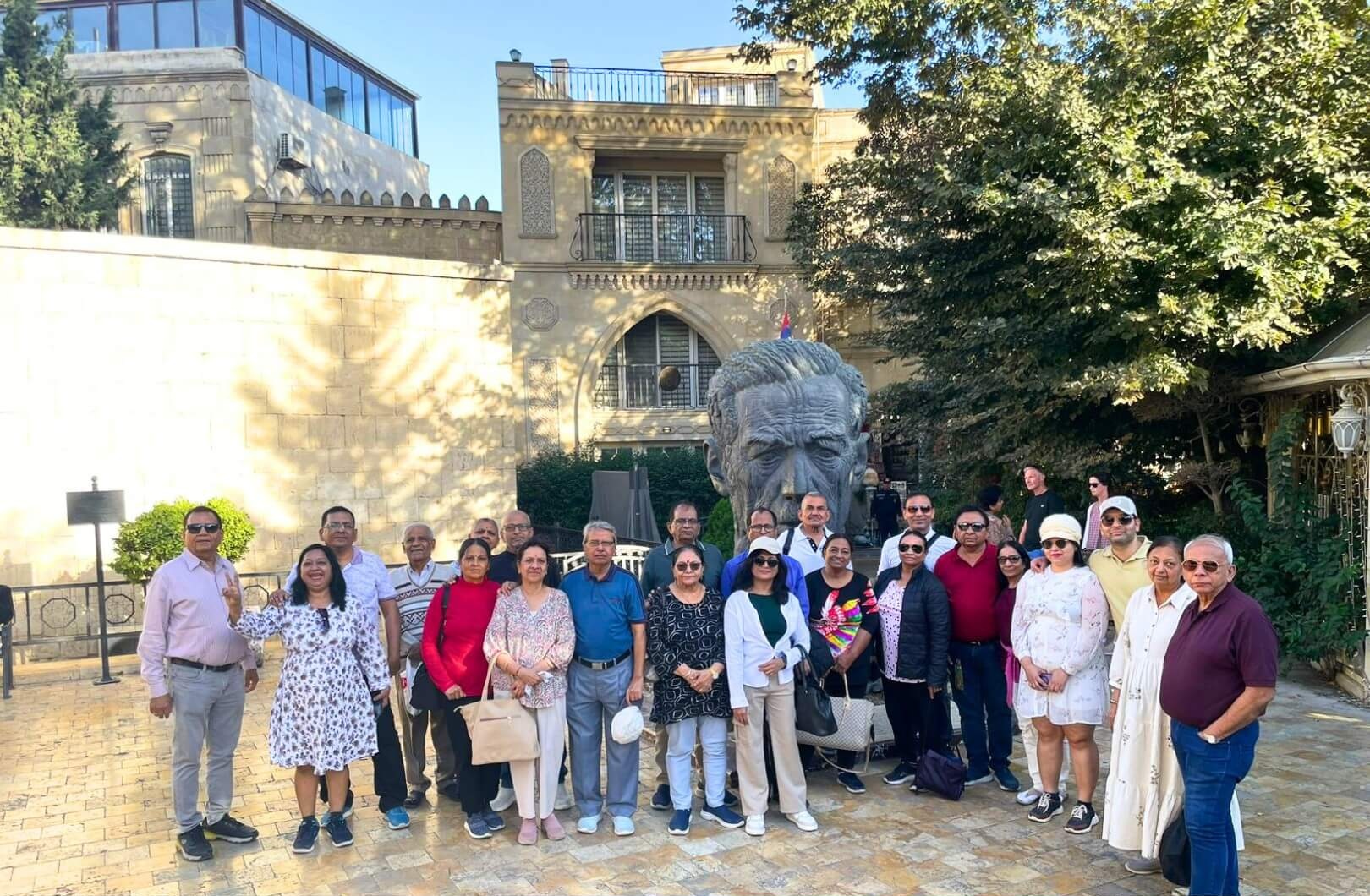 A collage of images from Azerbaijan, featuring a vibrant view of Baku's modern cityscape with the Flame Towers, a serene landscape of rural mountains, and a close-up of traditional food.