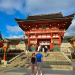 A collage of images showcasing different aspects of Japan, including a traditional temple in a lush garden, the bustling Shibuya crossing, a serene bamboo forest, and a majestic view of Mount Fuji.