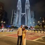 "Multiple distinct images of a Singapore city skyline, Malaysia's urban landmarks, and Langkawi's pristine beaches, combined into one, representing a multi-destination travel package."