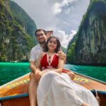 "The iconic Maya Bay, Phi Phi Leh, showcasing its dramatic limestone karsts surrounding a pristine beach and vibrant blue waters, a popular natural attraction."