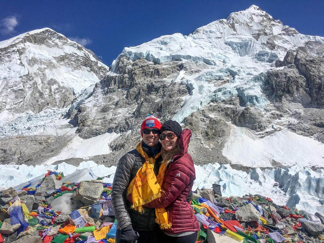 A collage of images from a Nepal honeymoon, featuring a couple in front of the snow-capped Himalayas, a scenic view of a lake with a boat, and a couple riding an elephant.