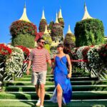 An exterior shot of a large floral sculpture of a castle at Dubai Miracle Garden, with vibrant flowers covering the entire structure.