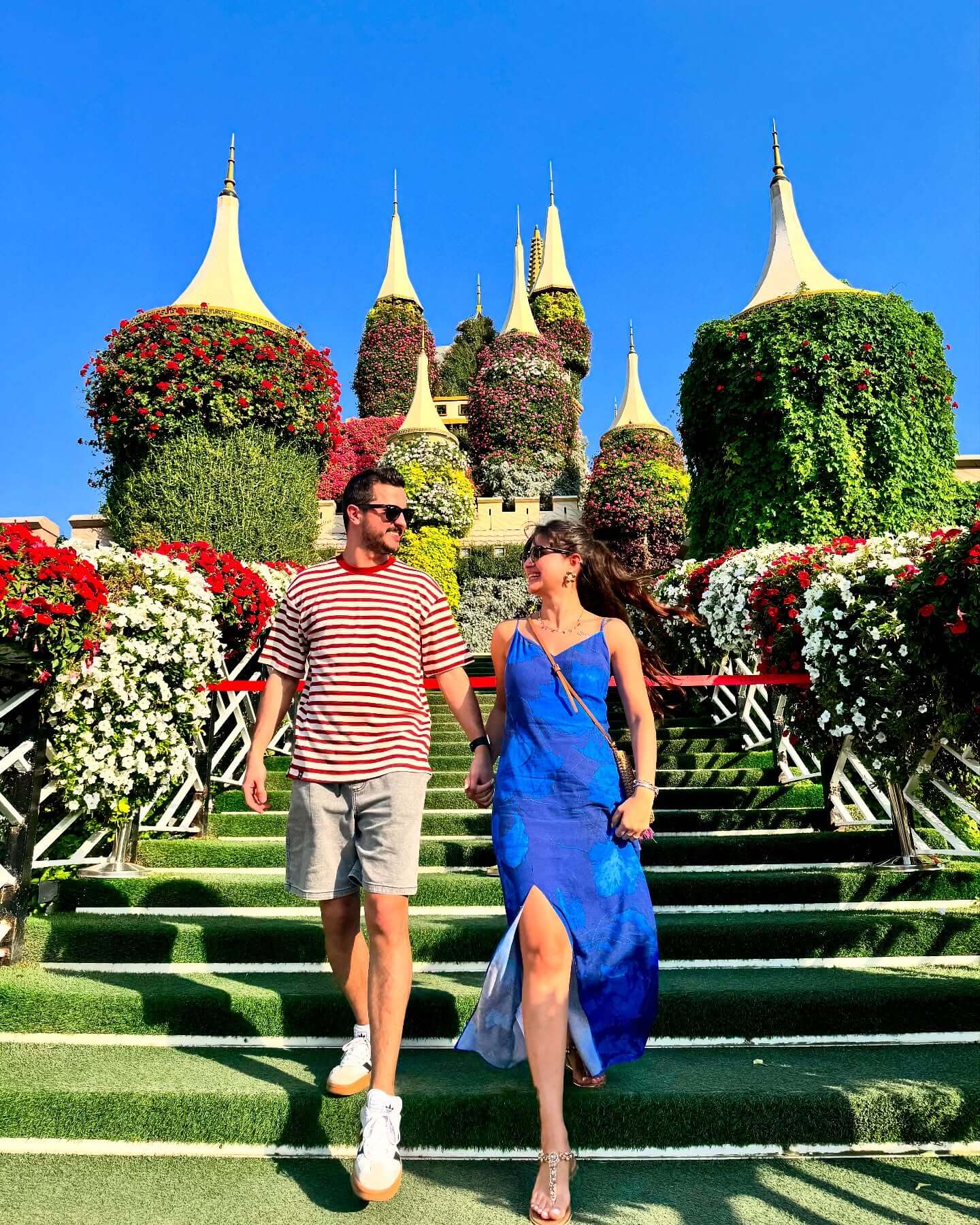 An exterior shot of a large floral sculpture of a castle at Dubai Miracle Garden, with vibrant flowers covering the entire structure.