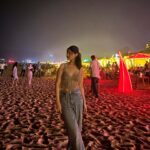 A lively view of Baga Beach in Goa, featuring shacks, sunbeds, and tourists enjoying the sand and sea, the ultimate Beach Destination in India.