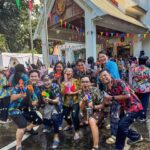 Tourists and locals celebrating Songkran festival with water guns on Khao San Road in Bangkok