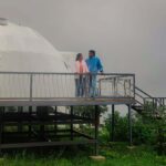 Romantic couple enjoying scenic view during a kodaikanal romantic package trip near Kodaikanal Lake with misty hills in background