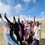 Travelers enjoying a scenic Spiti Valley trip with mountains, monasteries, and winding Himalayan roads