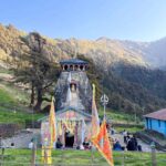 Madhyameshwar Temple surrounded by Himalayan mountains in Uttarakhand