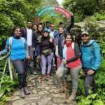 Valley of Flowers trek in Uttarakhand featuring colorful alpine flowers blooming across lush green meadows with snow-capped Himalayan mountains in the background.